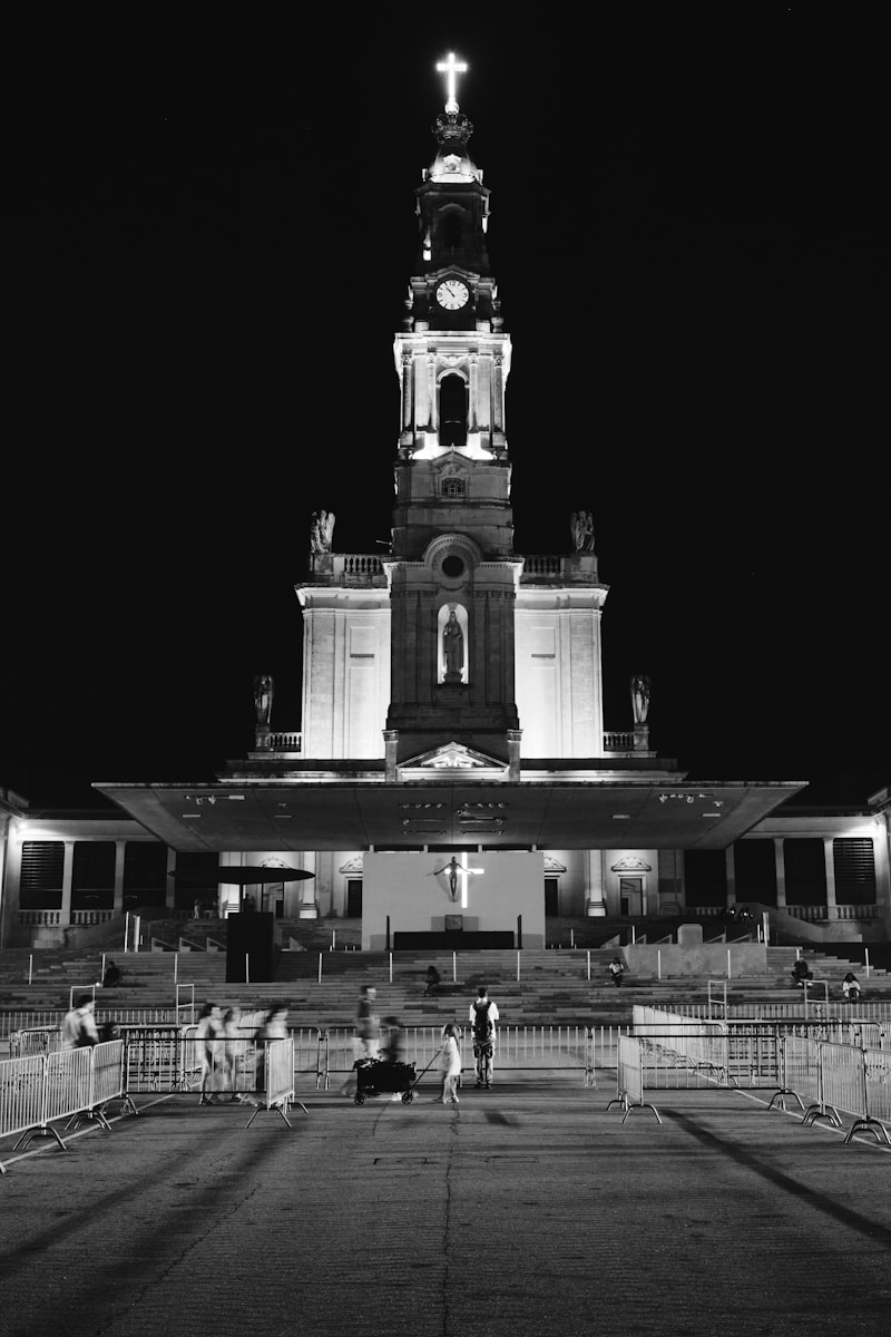 A black and white photo of a church at night