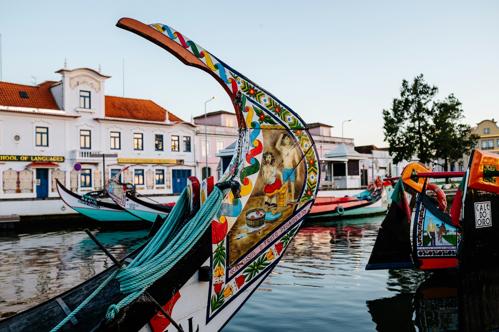 a row of colorful boats sitting on top of a body of water