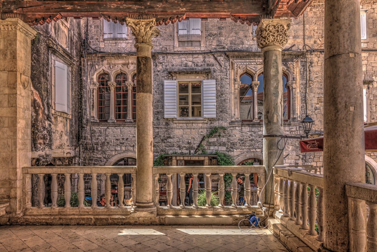 An old building with columns and a balcony